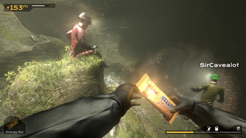 Player holding energy bar in underwater cave with two other divers nearby